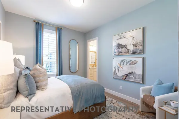 a bedroom with a bed and a painting on the wall