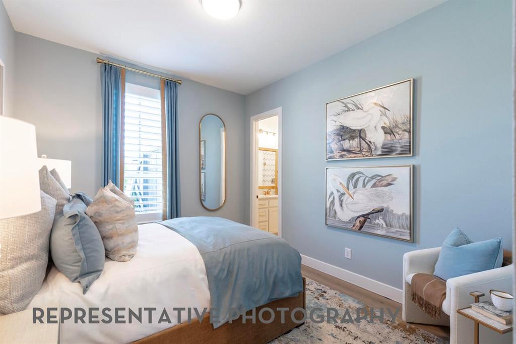 3908 Meander Way Prosper, TX 75078 - Photo 29 of 37 a bedroom with a bed and a painting on the wall