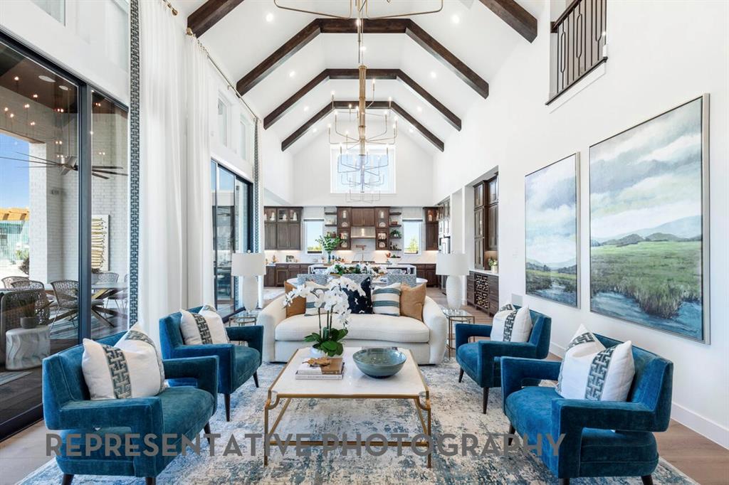 3908 Meander Way Prosper, TX 75078 - Photo 3 of 37 a living room with furniture a large window and a chandelier