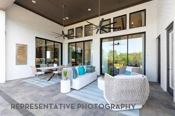 a living room with furniture and floor to ceiling windows