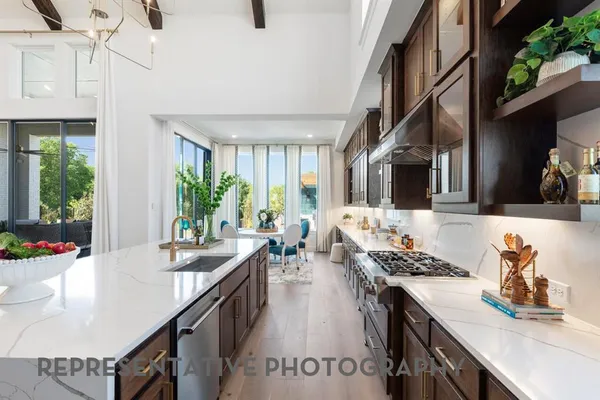a kitchen with stove a sink dishwasher and cabinets with wooden floor