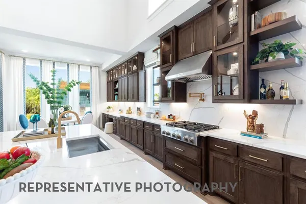 a kitchen with stainless steel appliances kitchen island granite countertop a sink dishwasher stove and cabinets