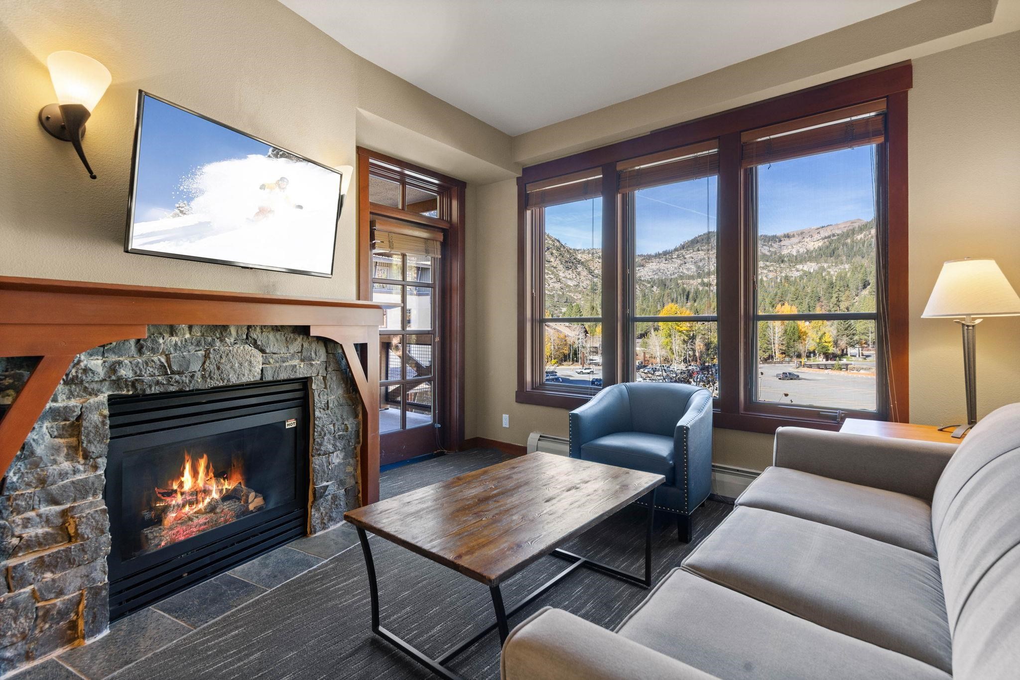 1850 Village South Road, Unit 4327 Olympic Valley, CA 96146 - Photo 2 of 25 a living room with furniture a flat screen tv and a fireplace