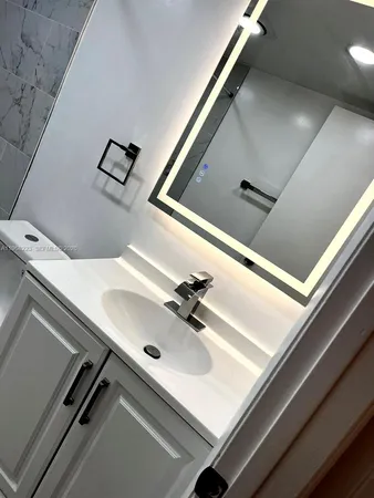 a bathroom with a shower a toilet and sink