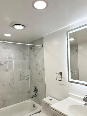 a bathroom with a sink a toilet and a bathtub