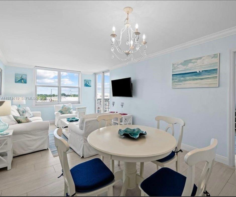 1505 North Riverside Drive, Unit 505 Pompano Beach, FL 33062 - Photo 7 of 9 a view of a dining room with furniture and a flat screen tv