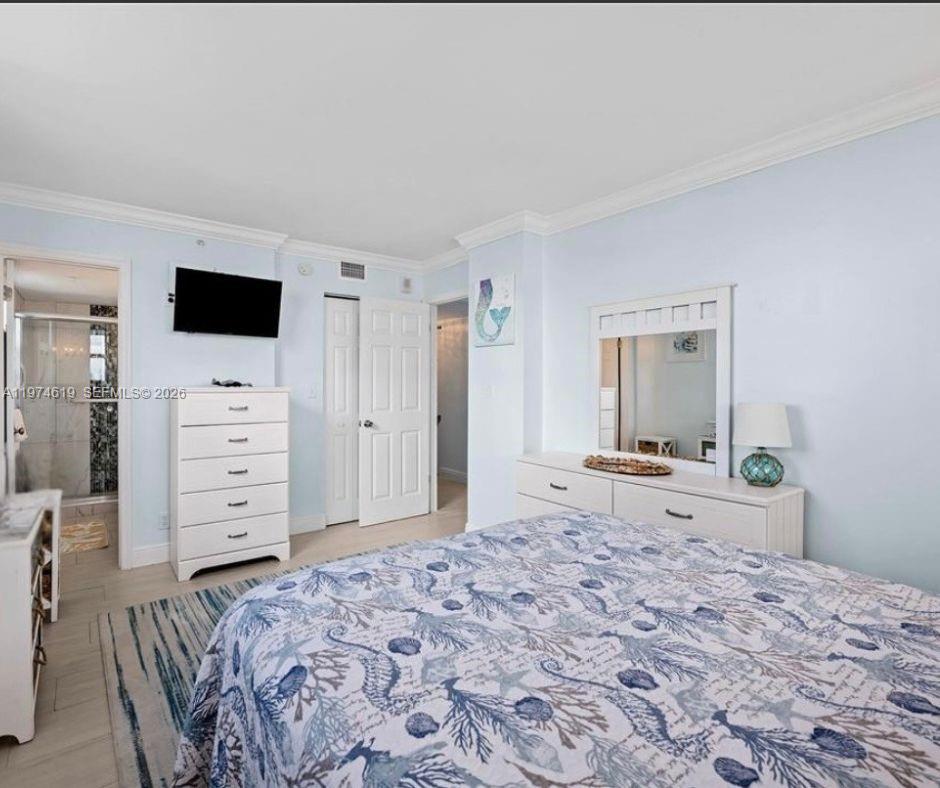 1505 North Riverside Drive, Unit 505 Pompano Beach, FL 33062 - Photo 8 of 9 a bedroom with a bed and a television