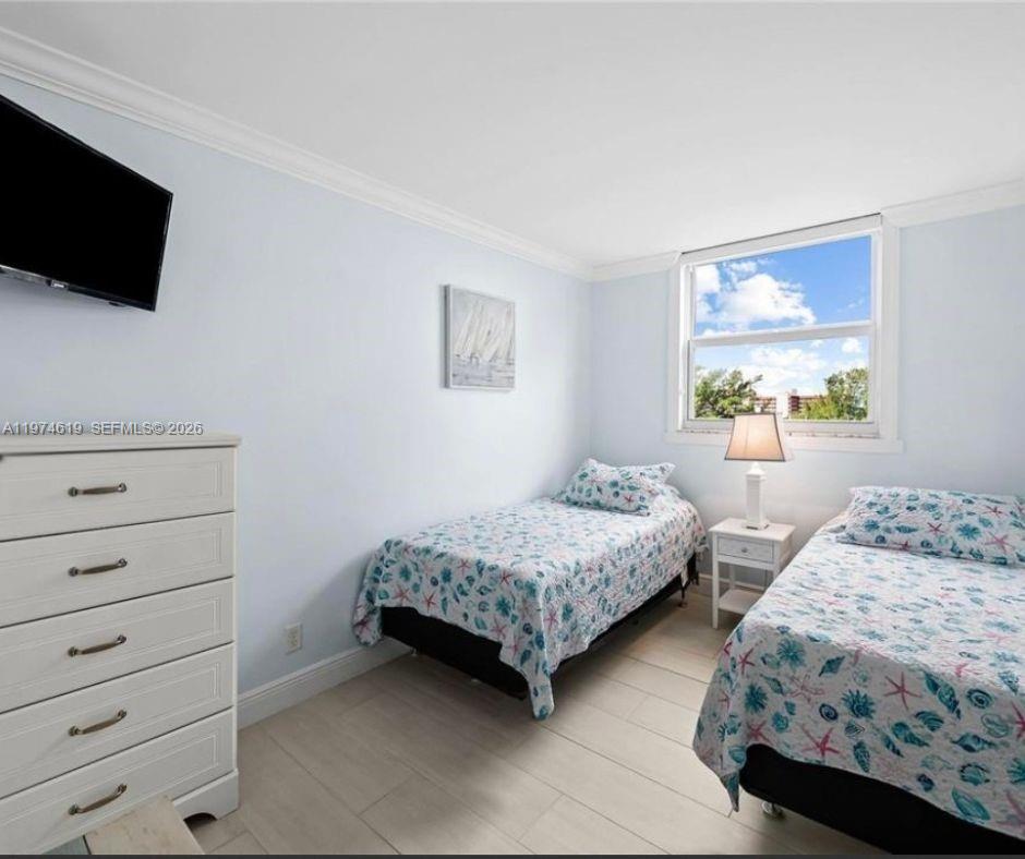1505 North Riverside Drive, Unit 505 Pompano Beach, FL 33062 - Photo 9 of 9 a bedroom with two beds and a flat screen tv