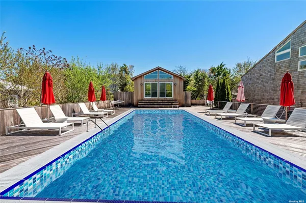 a view of a house with swimming pool and sitting area
