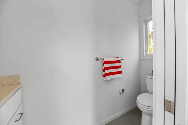a view of a patio with table and chairs potted plants with wooden floor and fence