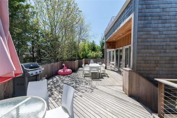 a view of a patio with couches table and chairs and potted plants