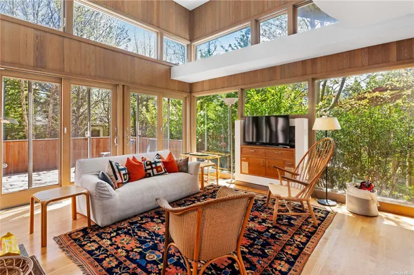 a living room with furniture and a floor to ceiling window