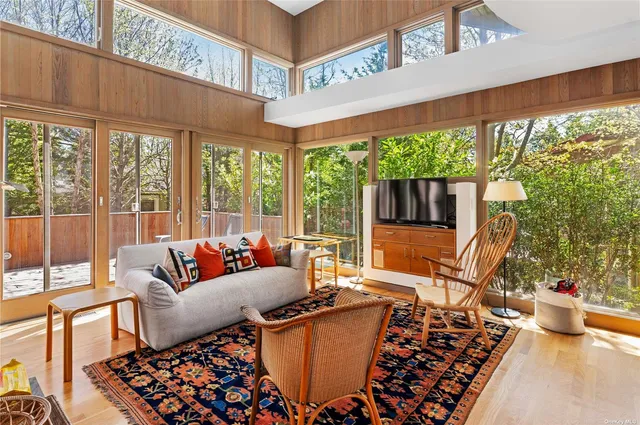a living room with furniture and a floor to ceiling window