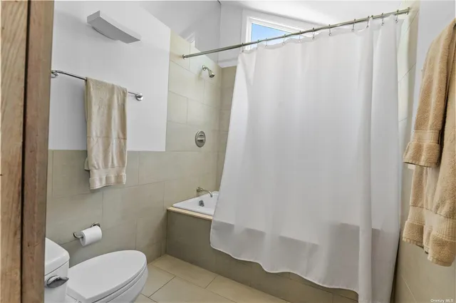 a bedroom with bed and window