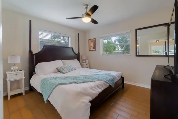 a bedroom with a bed and a mirror