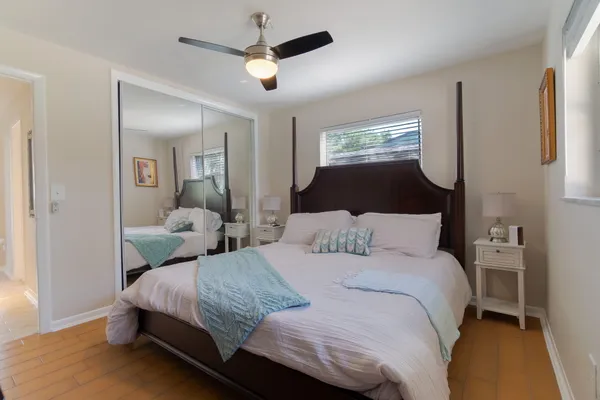 a bedroom with a large bed and a chandelier