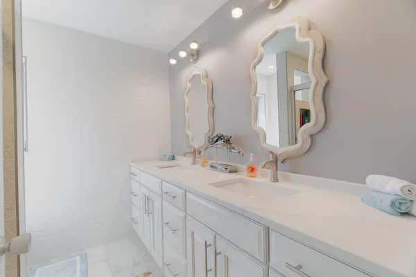 a bathroom with a double vanity sink and a mirror