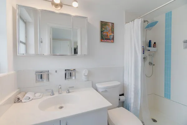 a bathroom with a sink toilet and shower