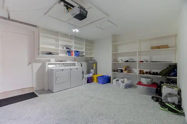 a utility room with cabinets dryer and washer