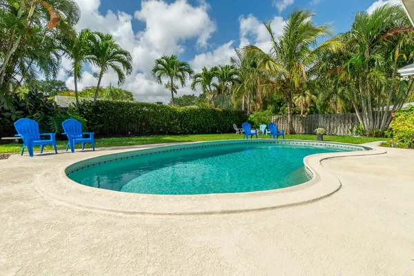 a view of a swimming pool and a yard