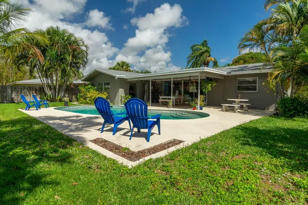 a view of a backyard with sitting area and slide