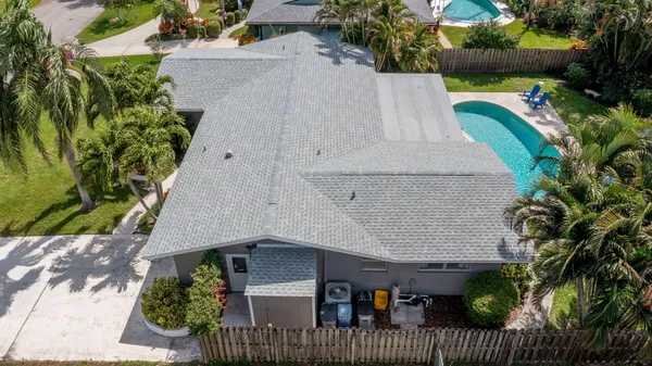 an aerial view of a house with a yard and potted plants