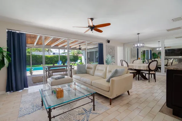 a living room with furniture a fireplace and a floor to ceiling window