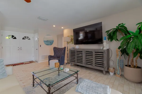 a living room with furniture and a flat screen tv