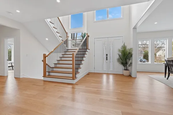 a view of entryway and hall with wooden floor
