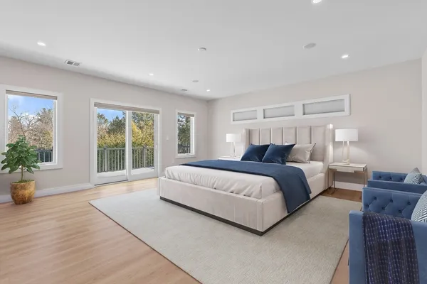 a bedroom with a large bed and a large window