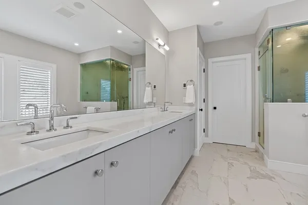 a spacious bathroom with a double vanity sink mirror and double