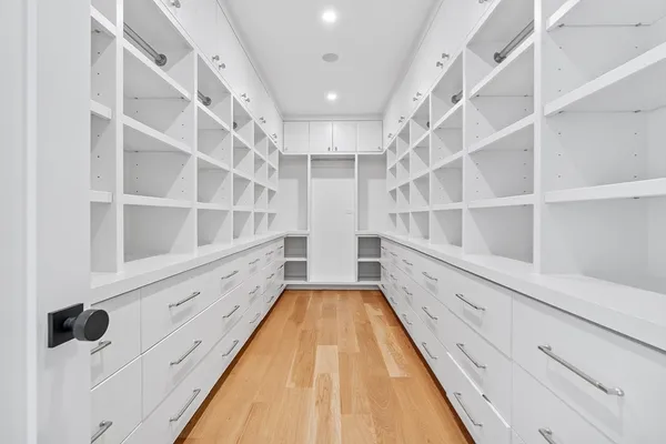 a view of walk in closet with empty racks