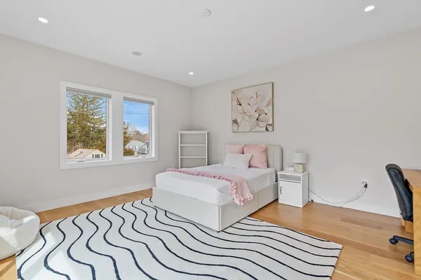 a bedroom with double bed and a window