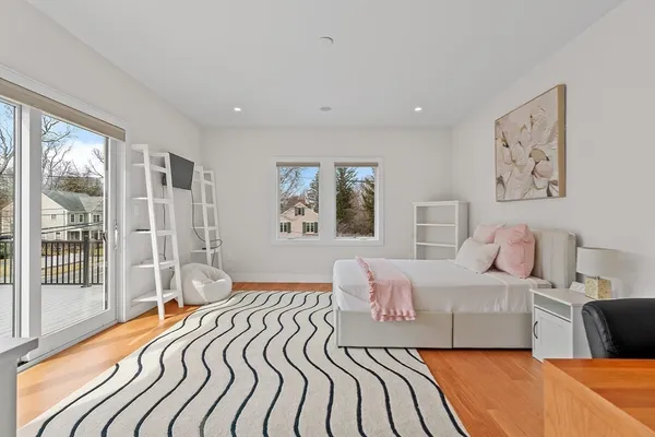 a bedroom with a large bed and a large window