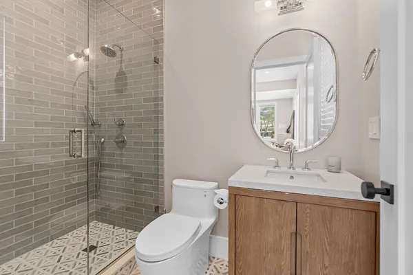 a bathroom with a sink a toilet and shower