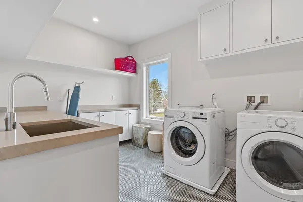 a utility room with sink dryer and washer