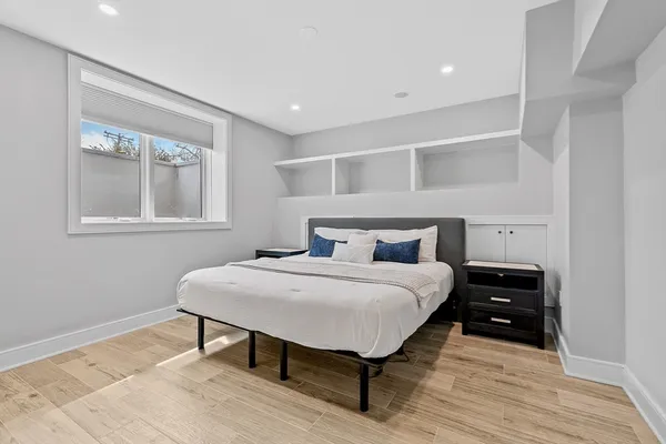 a bedroom with a bed and wooden floor
