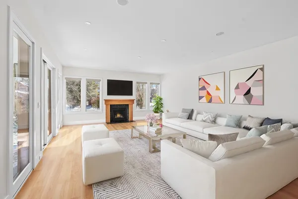 a living room with furniture a fireplace and a flat screen tv