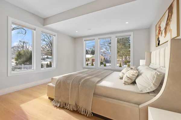 a bedroom with a bed and wooden floor