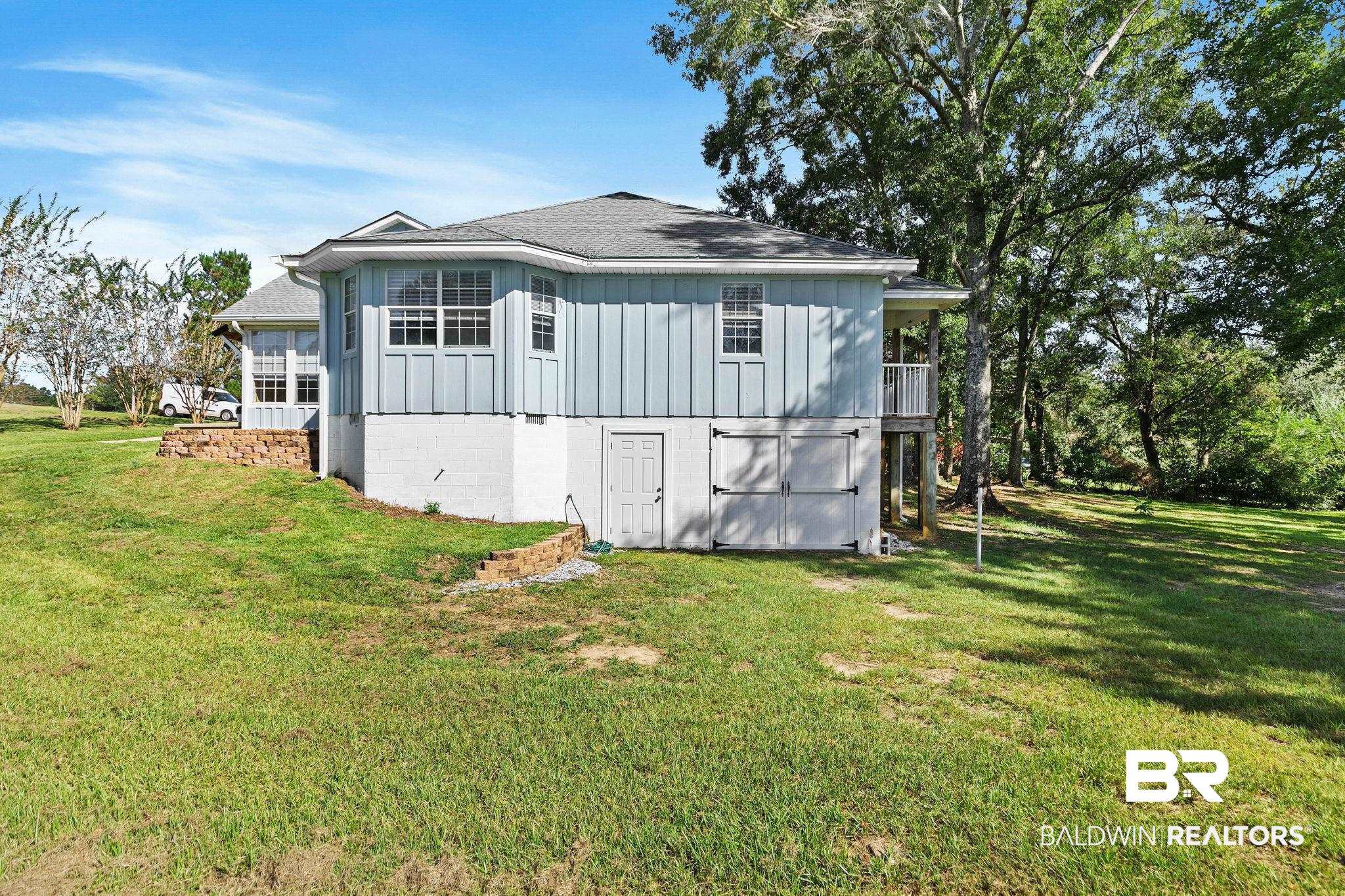 35650 Spring Road North Stapleton, AL 36578 - Photo 54 of 70 Back of property with hardie siding, a yard, and a balcony