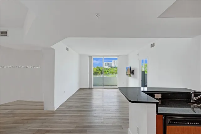 a view of a kitchen with a stove wooden floor and a refrigerator