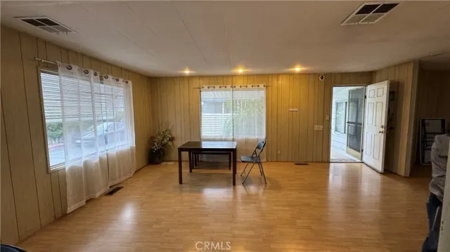 a view of a livingroom with furniture window and wooden floor