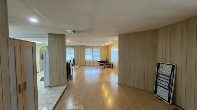 a view of a hallway with wooden floor fireplace and living room