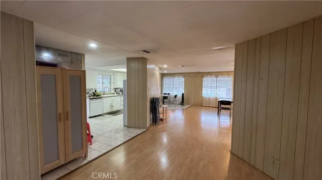 a view of a hallway with dining room and furniture