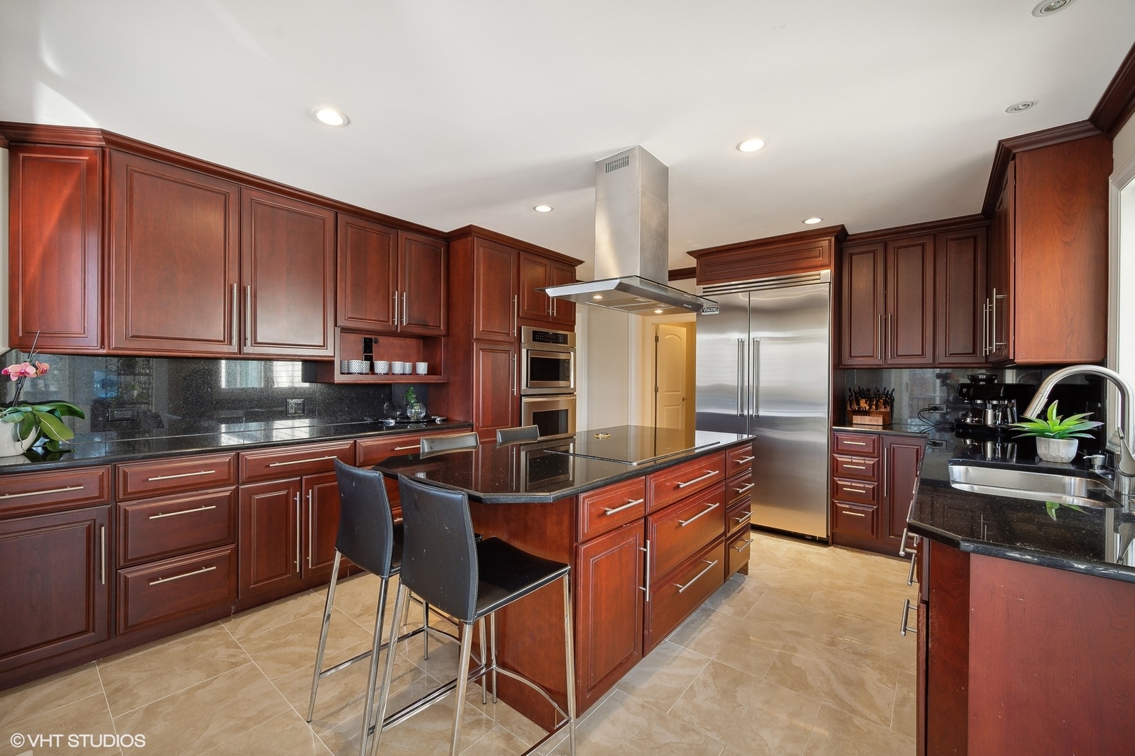 1640 Pfingsten Road Northbrook, IL 60062 - Photo 4 of 34 a kitchen with stainless steel appliances granite countertop wooden cabinets a stove top oven a sink and dishwasher