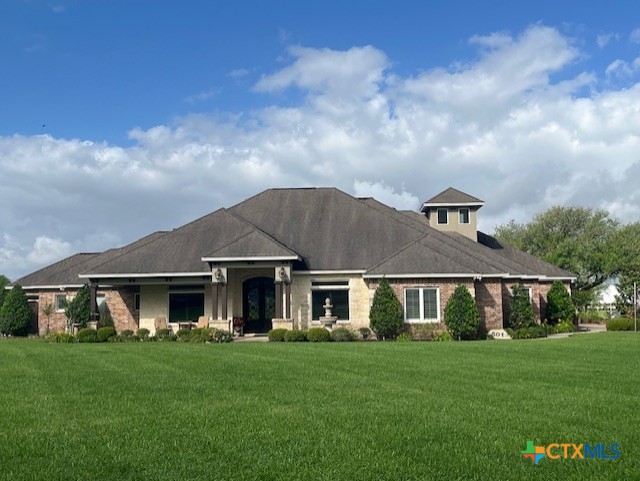 501 Barbara Street Ganado, TX 77962 - Photo 1 of 43 a front view of a house with a garden