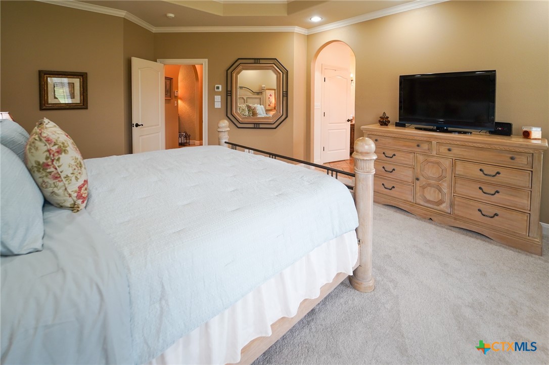 501 Barbara Street Ganado, TX 77962 - Photo 14 of 43 a bedroom with a bed and a flat screen tv