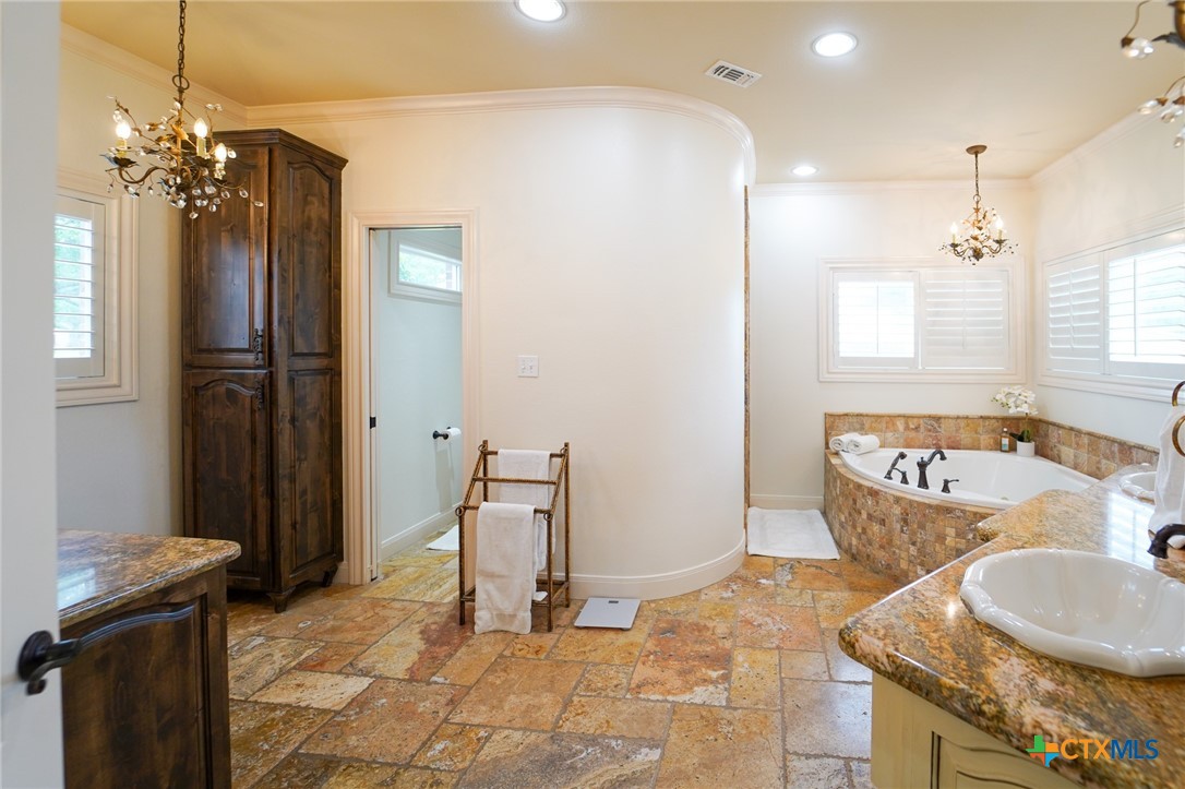 501 Barbara Street Ganado, TX 77962 - Photo 15 of 43 a bathroom with a granite countertop sink and a mirror