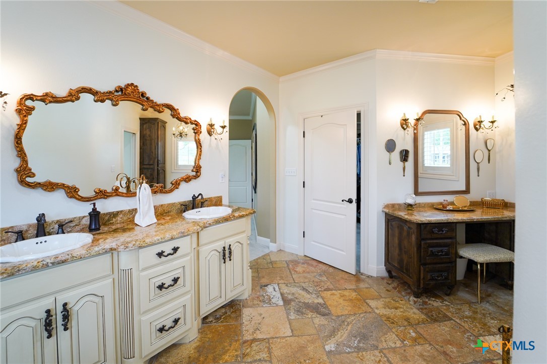 501 Barbara Street Ganado, TX 77962 - Photo 16 of 43 a spacious bathroom with a double vanity sink and a mirror