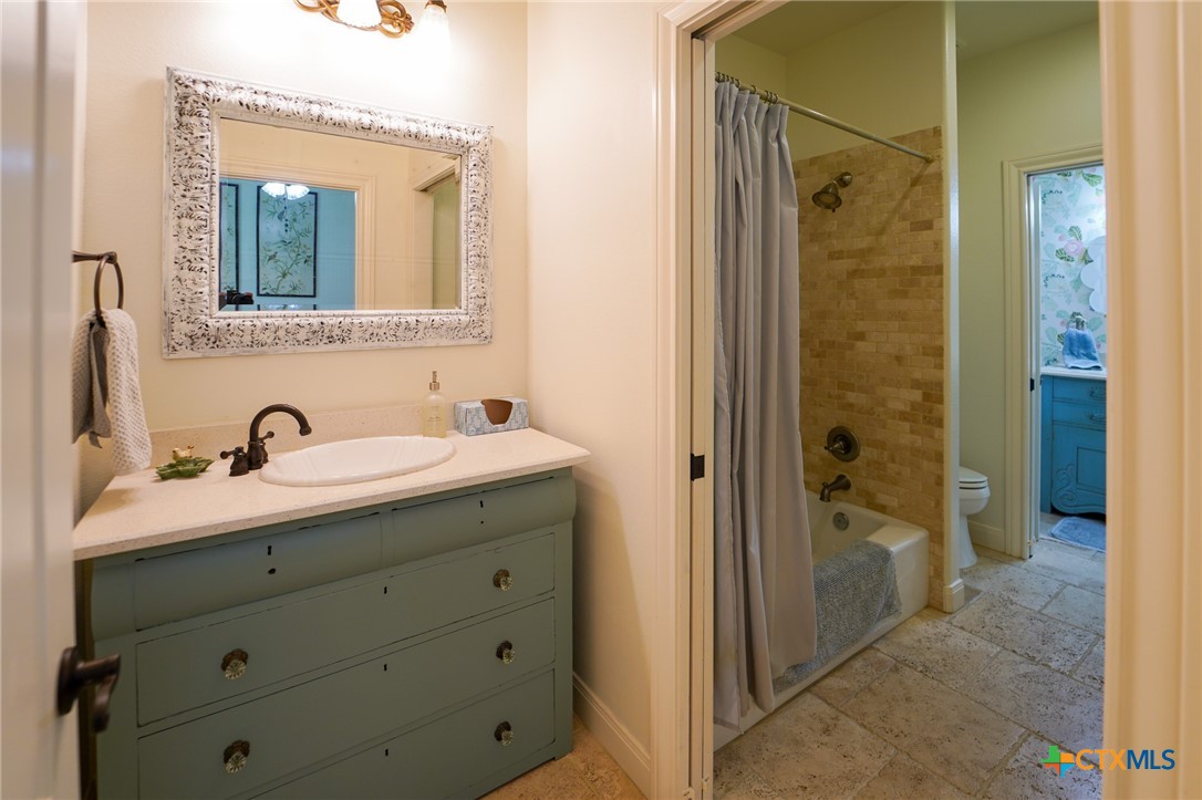 501 Barbara Street Ganado, TX 77962 - Photo 19 of 43 a bathroom with a shower sink and mirror